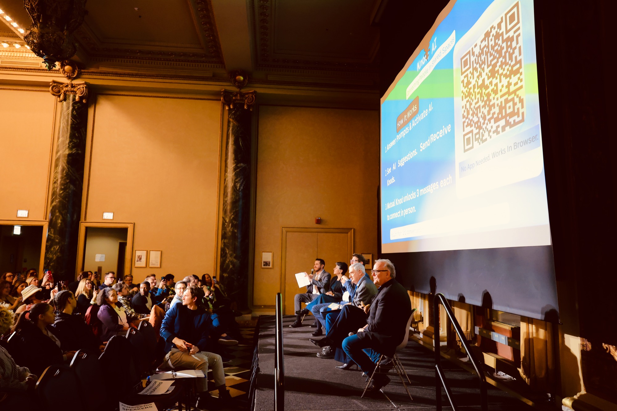 A Chicago Innovation panel on stage with the Knod screen behind them